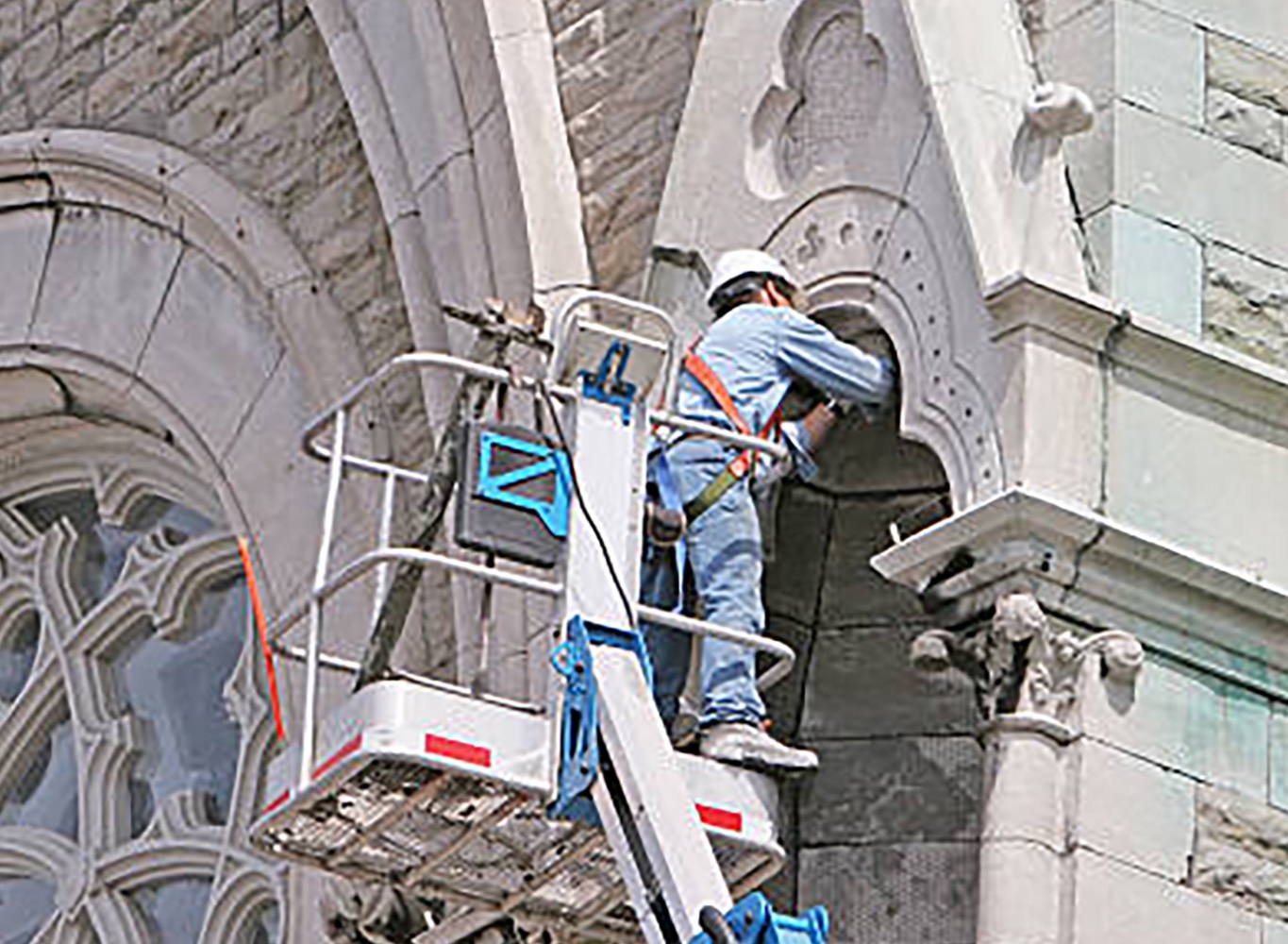 Worker restoring a church.