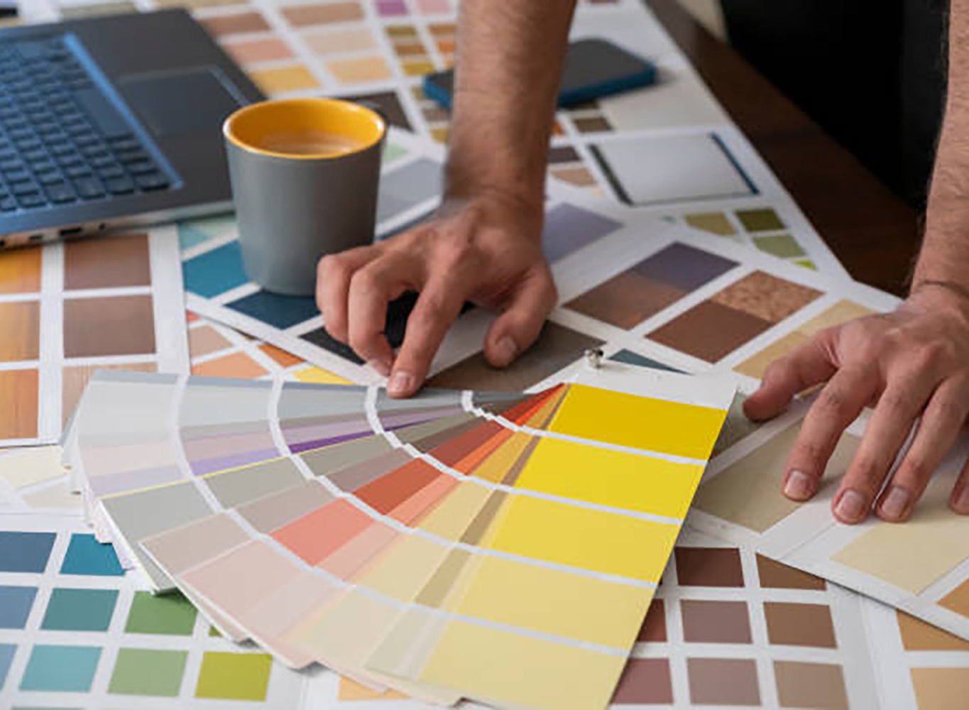 Close-up Designer man showing swatch from colored papers